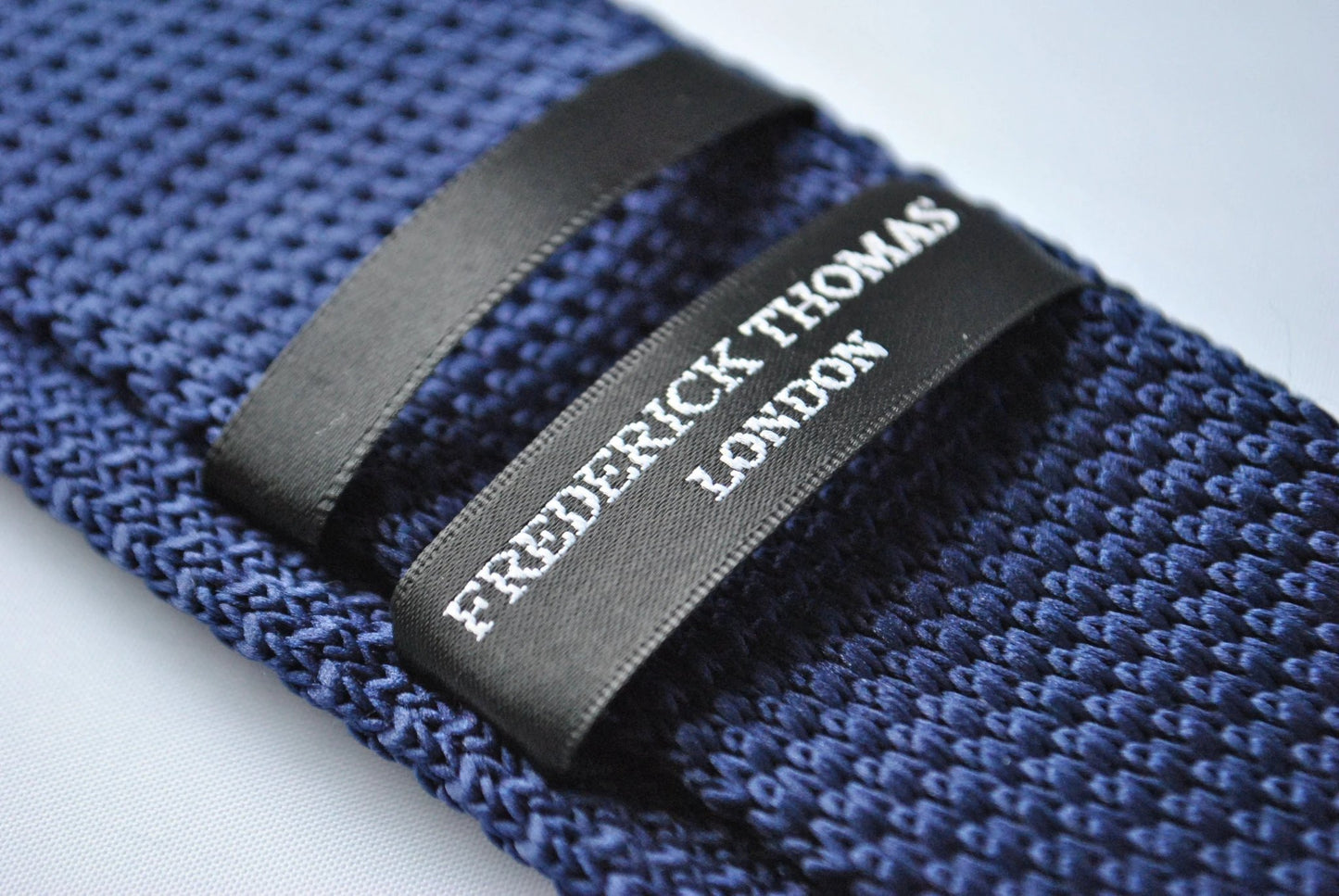 navy blue skinny knitted tie with green polka dots by Frederick Thomas Handmade Mens Ties