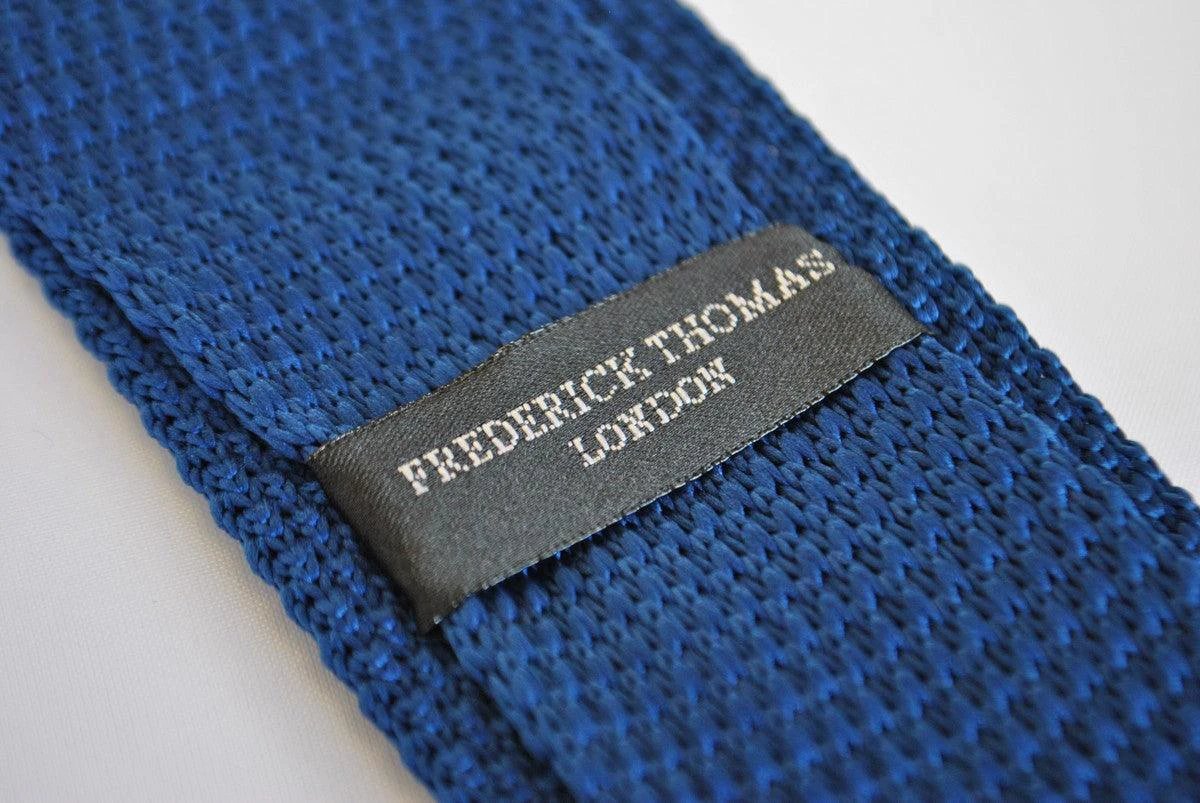 navy blue skinny knitted tie with white polka dots and pointed end by Frederick Thomas Handmade Mens Ties